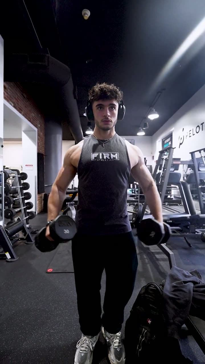 A Firm Athletics member training with dumbbells in the gym, from the studio's brand film